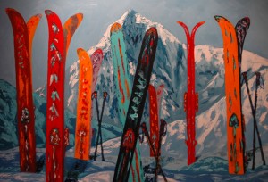snowskis vertically arranged in snow with mountain backdrop